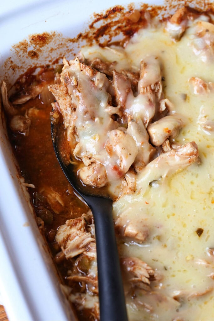 Slow Cooker Taco Chicken is so easy to make. Use it in tacos, rice bowls or on nachos! A slow cooker chicken recipe that everyone loves. slow cooker chicken topped with cheese