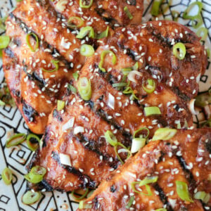 grilled chicken breasts on a platter with Asian marinade