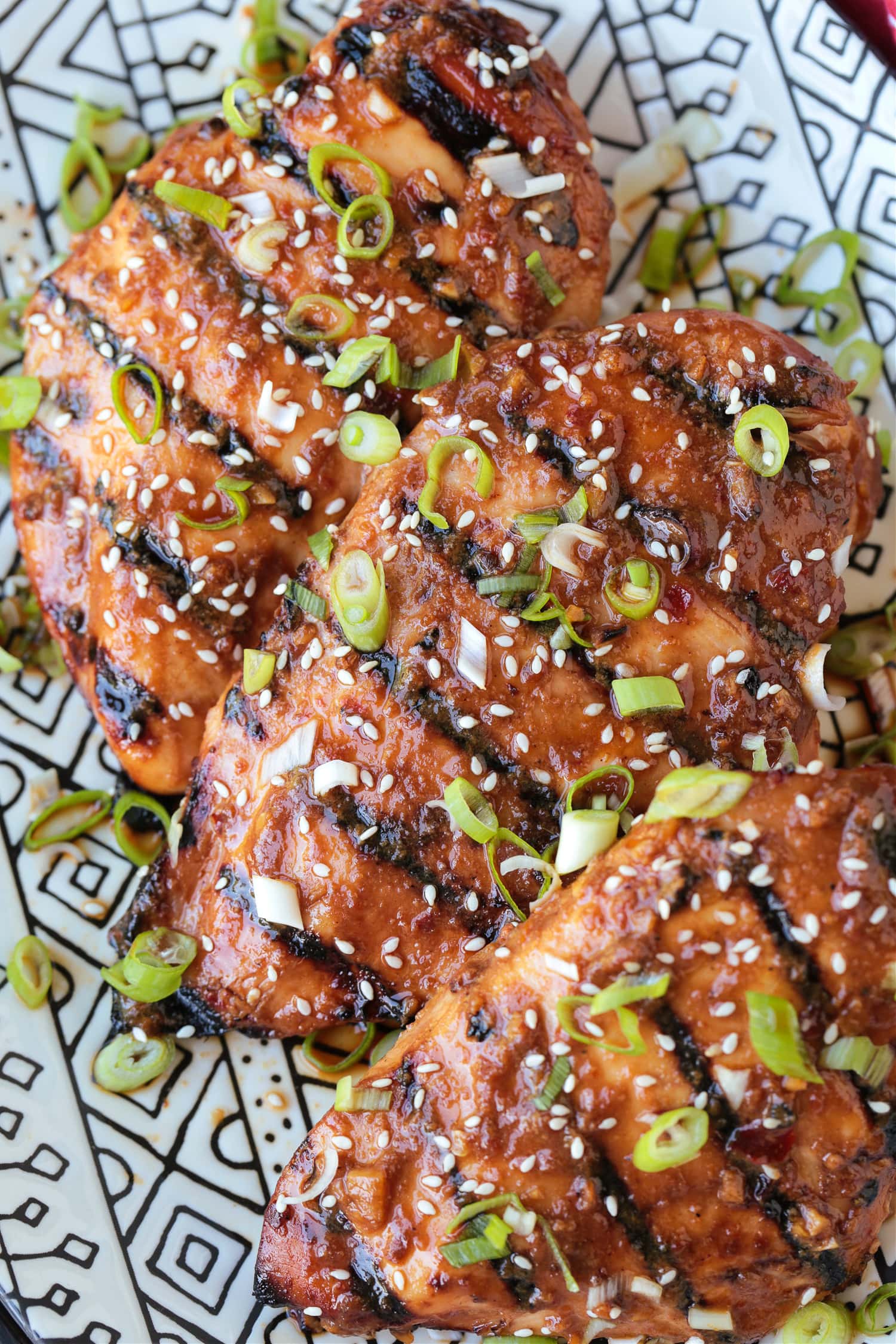 grilled chicken breasts on a platter with Asian marinade