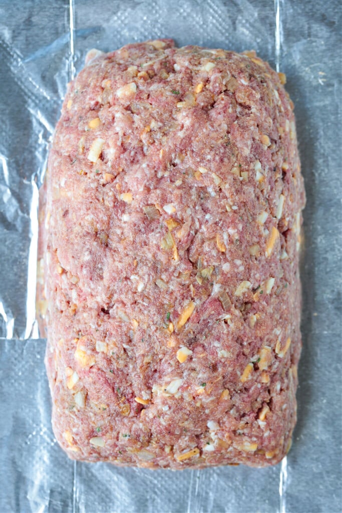 uncooked meatloaf on sheet pan