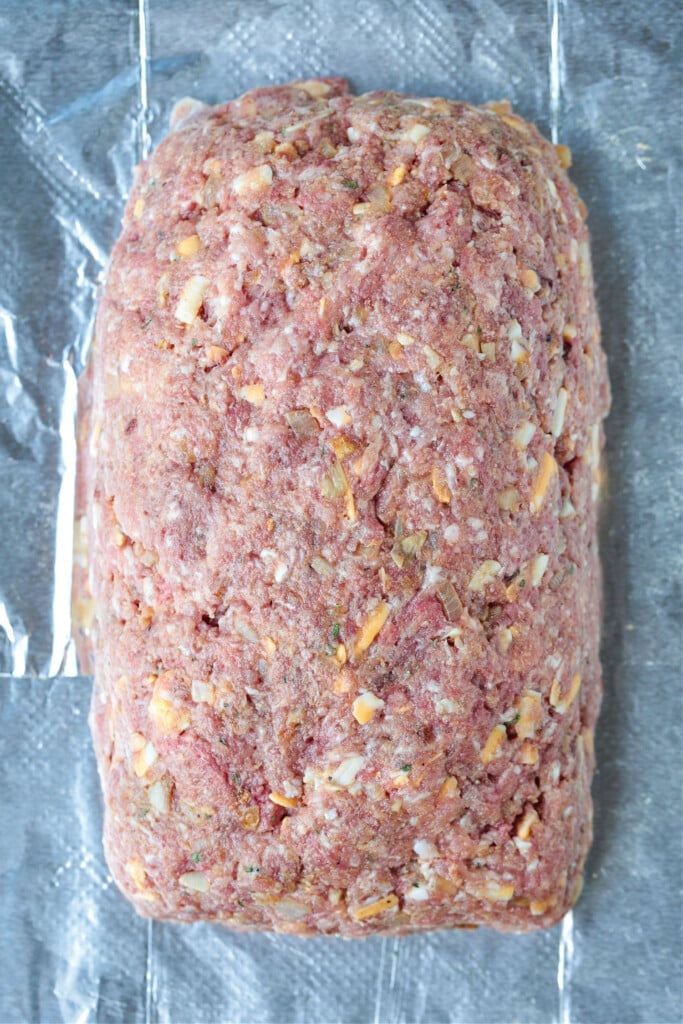 What could be more comforting than a Bacon Meatloaf for dinner? A delicious meatloaf recipe with cheddar cheese and lots of crispy bacon! uncooked meatloaf on sheet pan