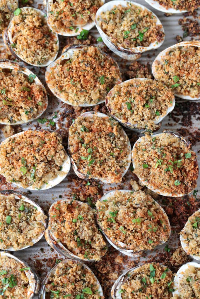 Baked Clams are always a hit! Fresh, steamed clams topped with a buttery breadcrumb topping. A delicious seafood appetizer or dinner! baked clams with breadcrumb topping