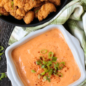 bang bang sauce in a bowl with chicken on the side