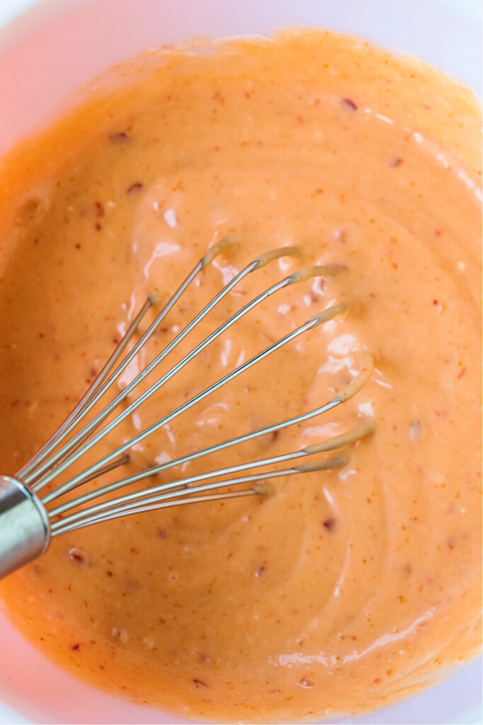 bang bang sauce in a bowl with whisk