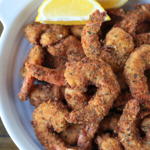 breaded shrimp in a dish with lemon