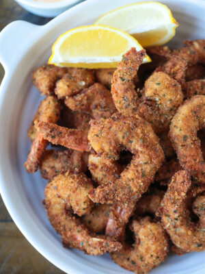 breaded shrimp in a dish with lemon
