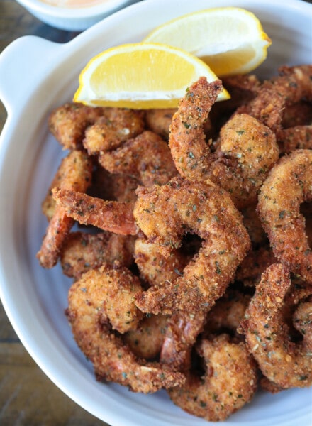 breaded shrimp in a dish with lemon