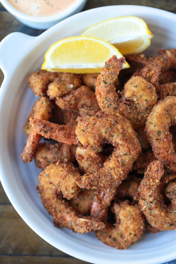 breaded shrimp in a dish with lemon