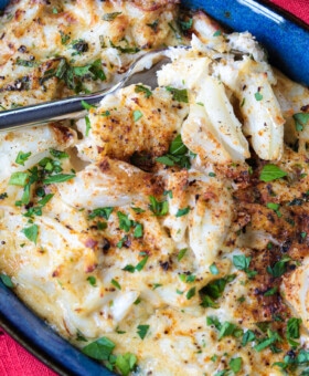 crab imperial in blue dish with fork