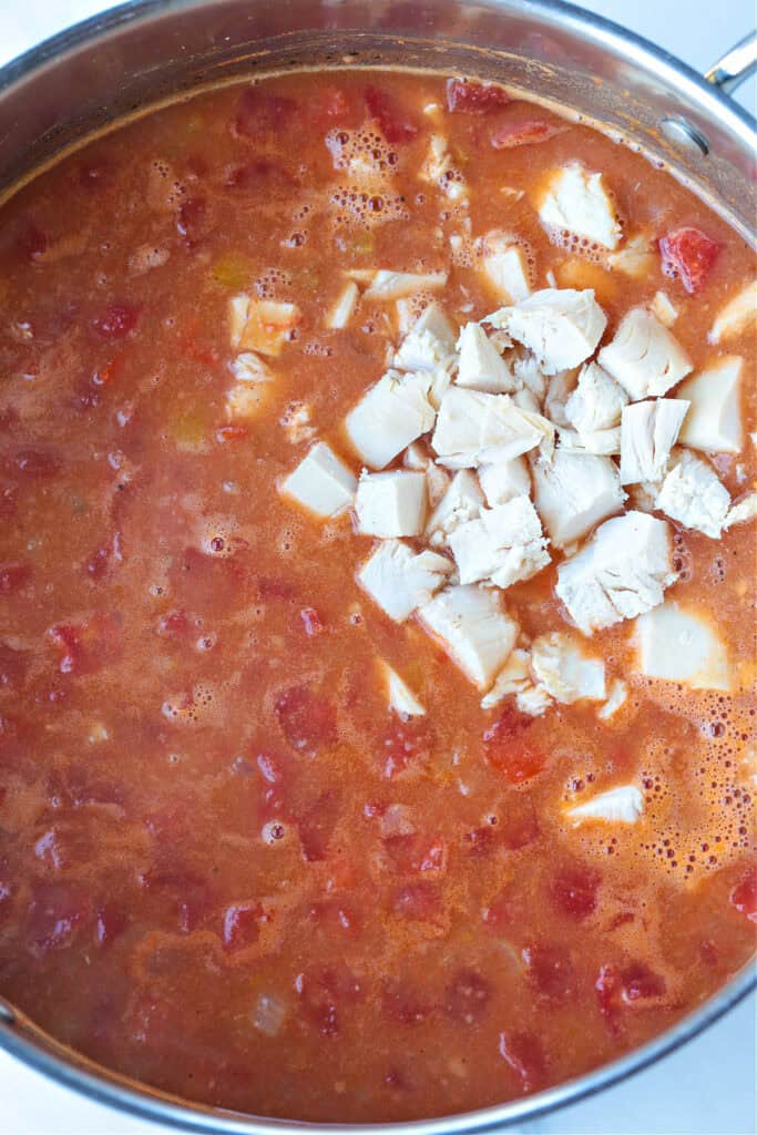 Our Chicken Fajita Soup is packed with protein! A secret ingredient makes this soup thick and creamy, without any cream or cream cheese! soup in a pot with diced chicken