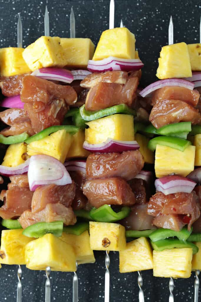 Chicken Pineapple Kabobs are a fun and tasty dinner! Sweet, grilled pineapple combined with juicy, marinated chicken and roasted vegetables. chicken, vegetables and pineapple on skewers