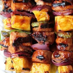 close up of chicken and pineapple kabobs on skewers