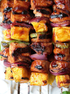 chicken and pineapple kabobs on white platter