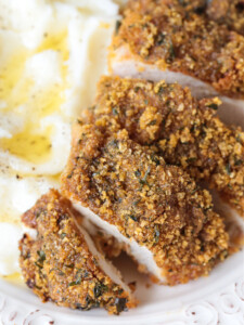 cornflake chicken on a plate with mashed potatoes