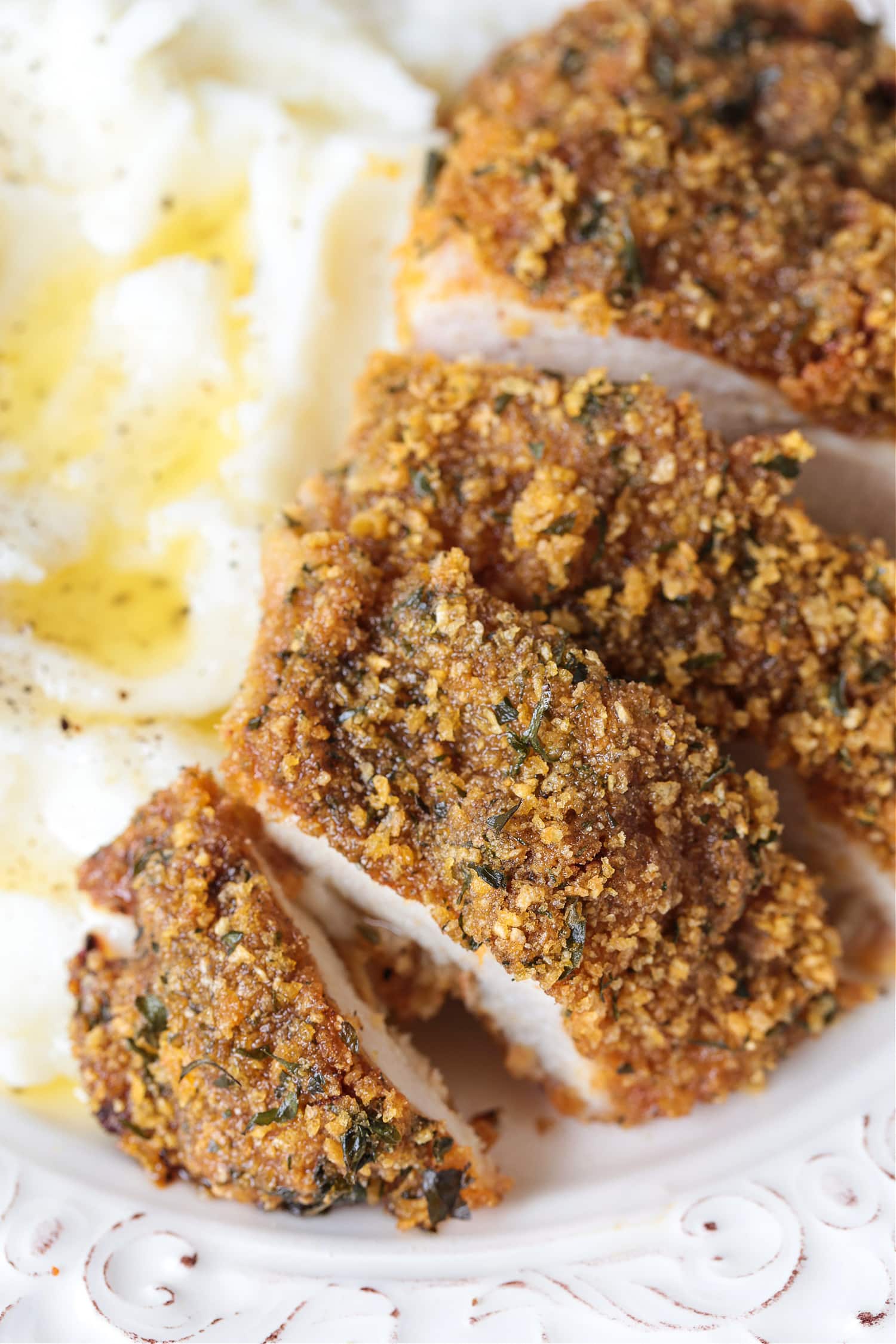 cornflake chicken on a plate with mashed potatoes