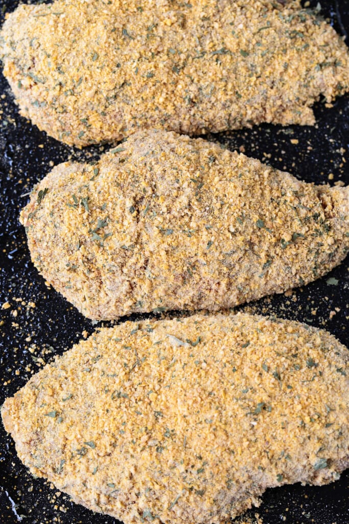 breaded chicken breasts on board