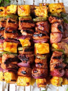 chicken and pineapple kabobs in platter