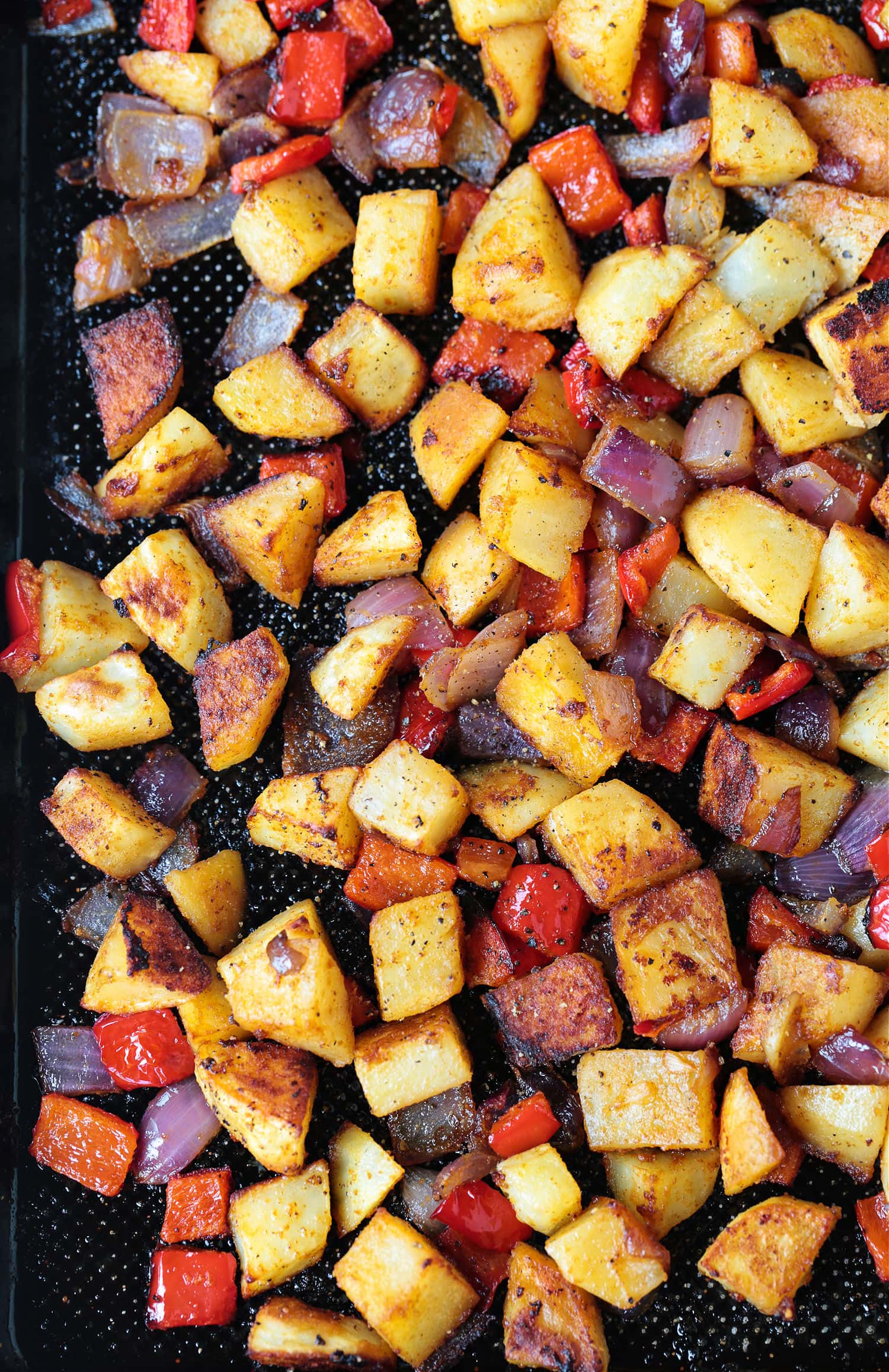 These Breakfast Potatoes are deliciously seasoned and roasted to a crispy perfection! A tasty side dish for breakfast, brunch or dinner! breakfast potatoes on a sheet pan