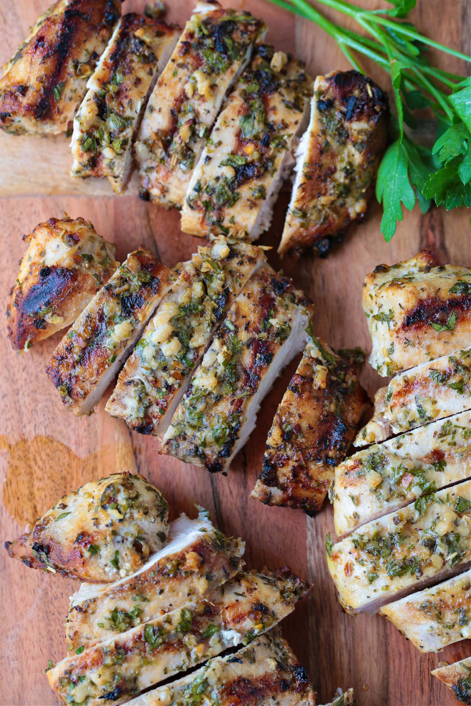 sliced, marinated chicken breast on a cutting board