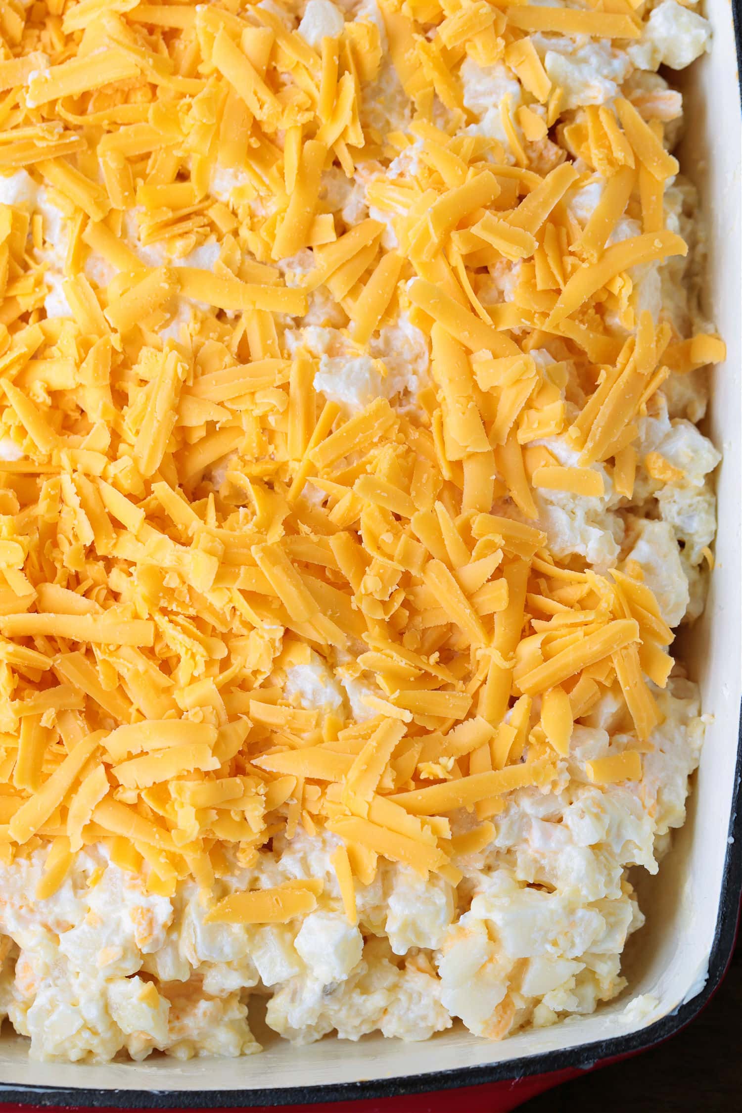 potato casserole with cheese on top in baking dish