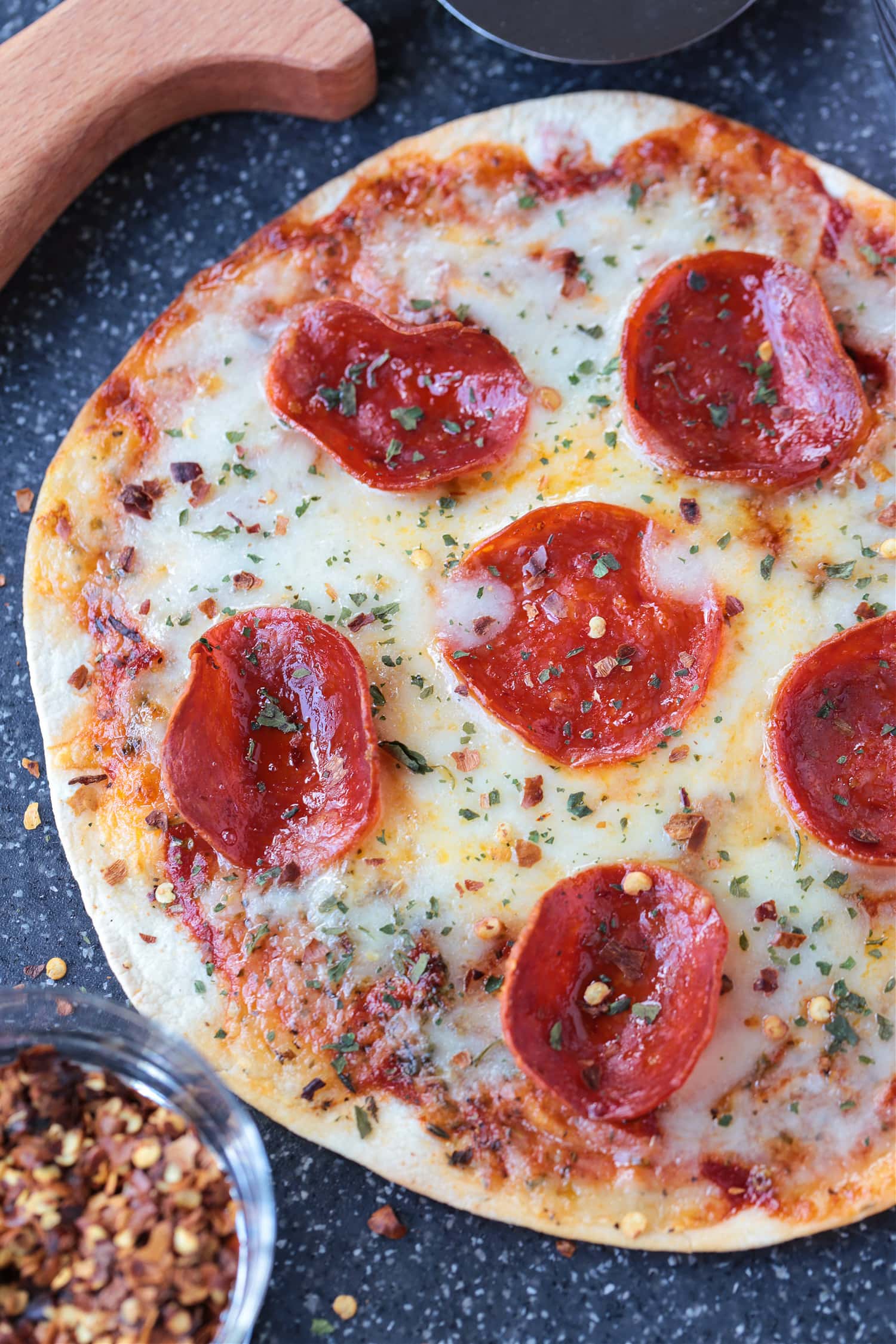 air fryer pizza with pepperoni on cutting board