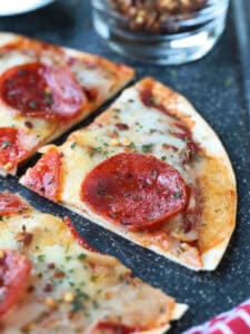 tortilla pizza cut into a wedge