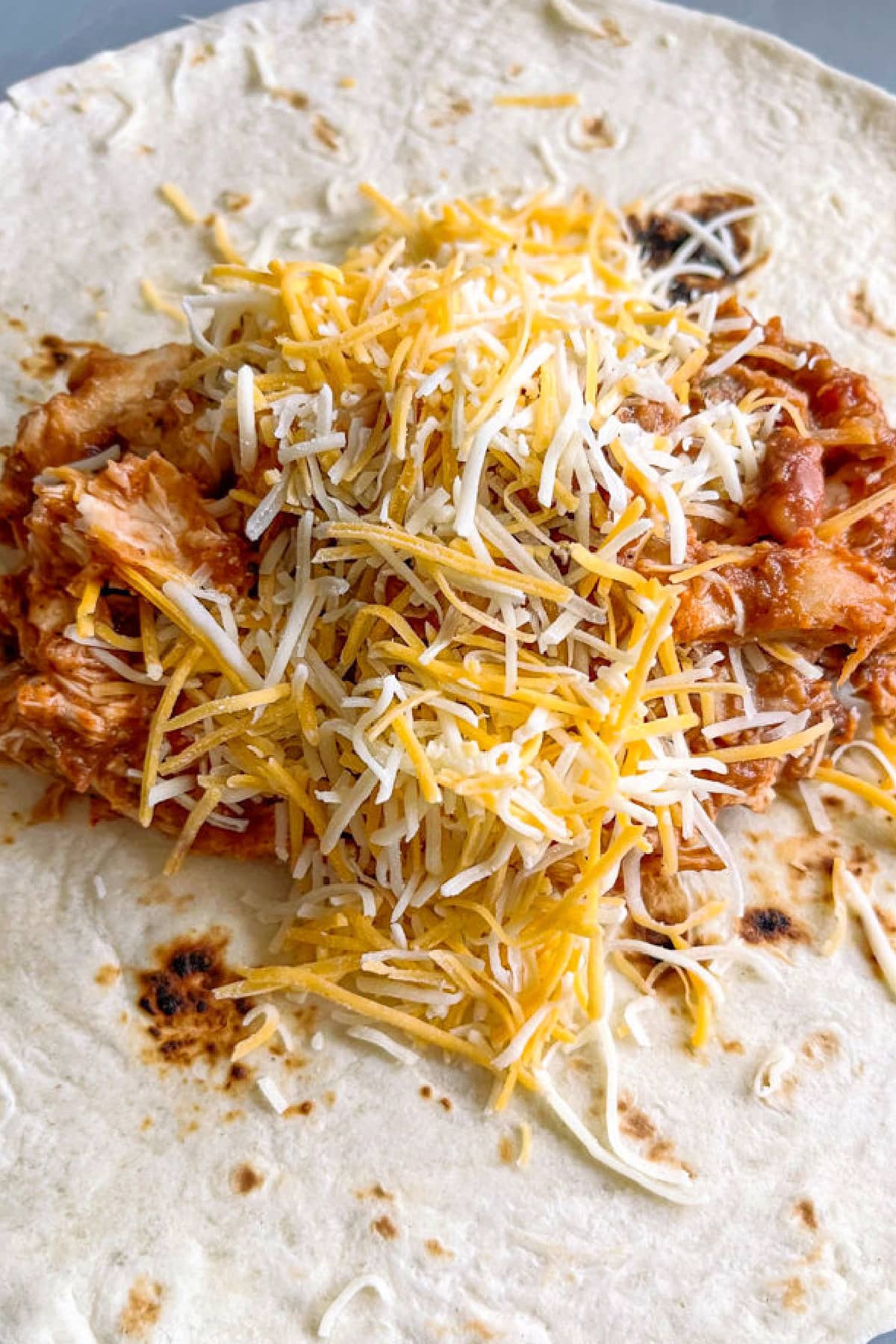 Chicken Chimichangas are super crispy and oozing with flavor! A chicken and cheese filling tucked inside a crispy, pan-fried tortilla. Chicken filling with cheese in a tortilla