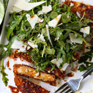 Chicken Milanese on a white plate with fork