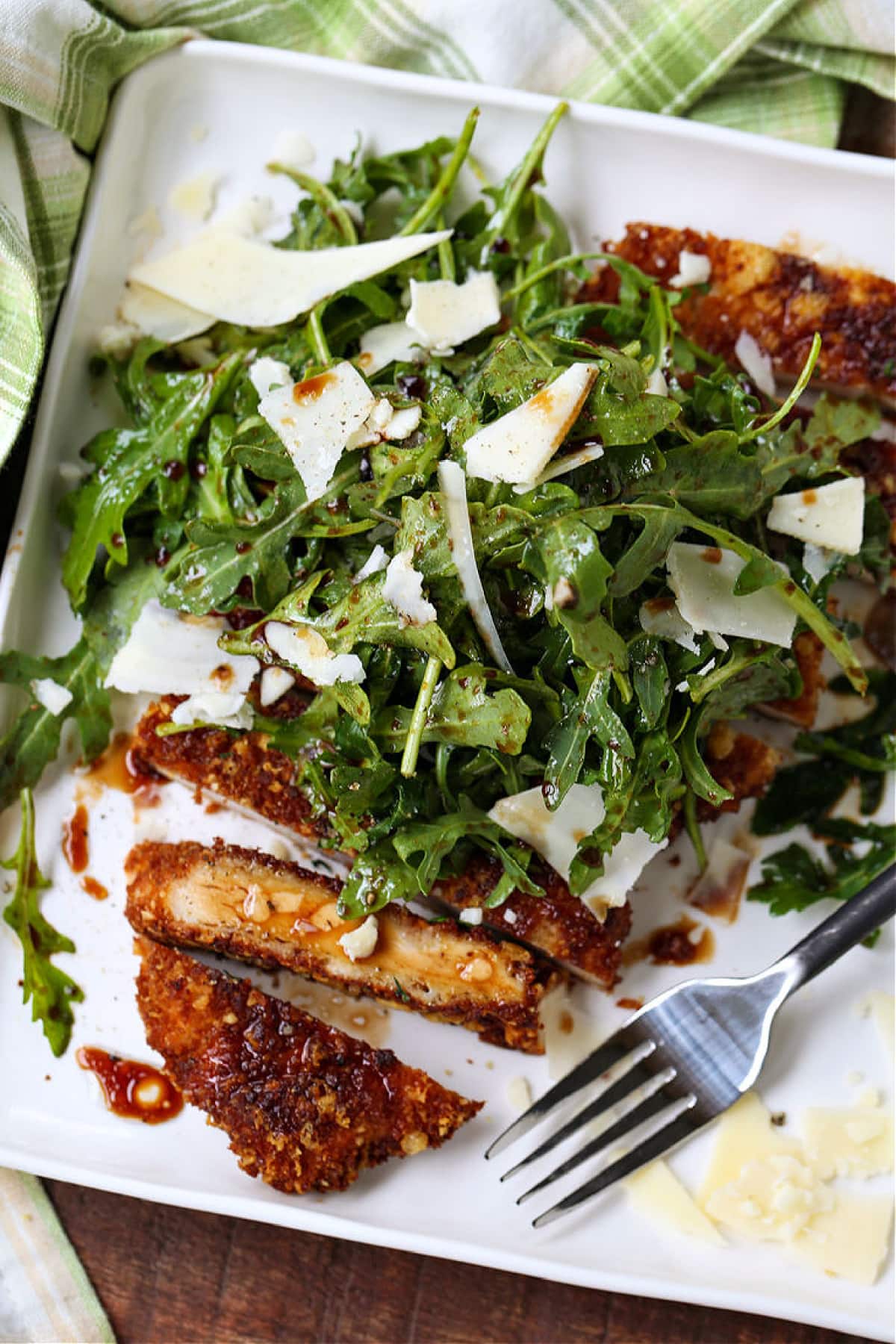 Chicken Milanese on a white plate with fork