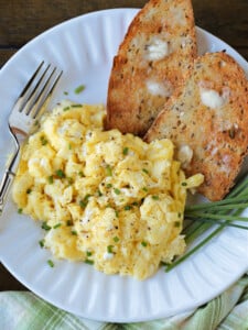 scrambled eggs with cottage cheese on a plate with toast