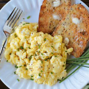 scrambled eggs with cottage cheese on a plate with toast