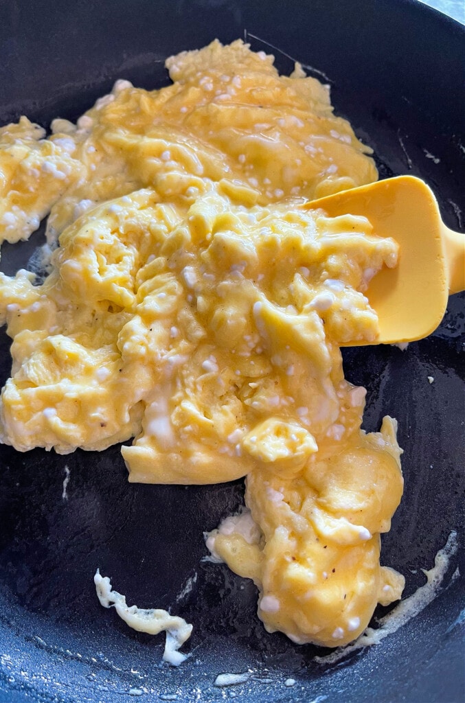 scrambled eggs in skillet with spatula