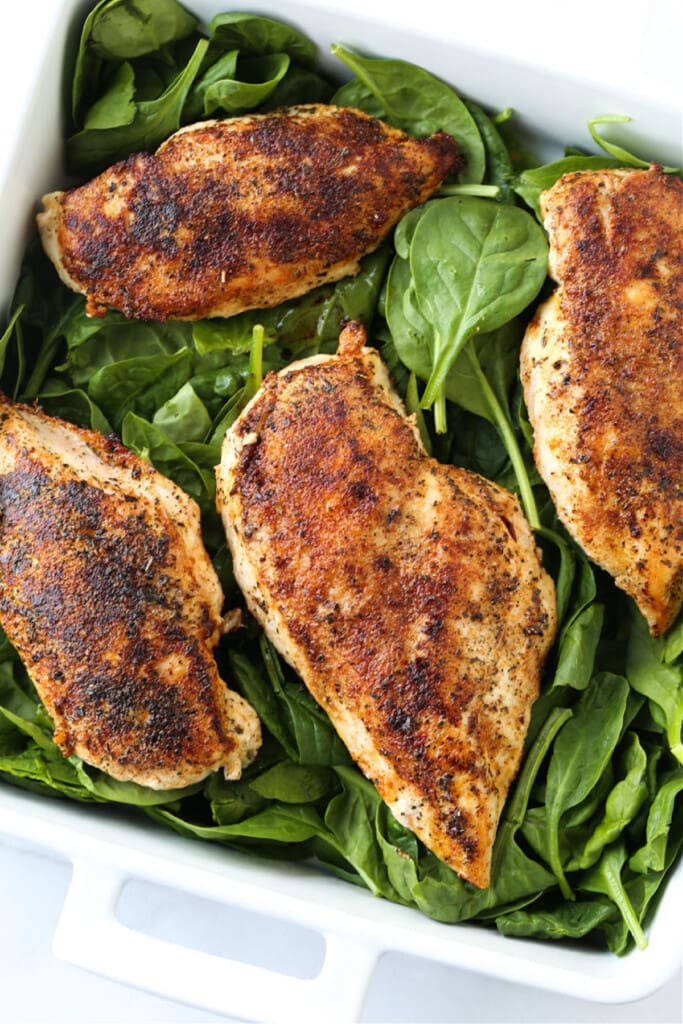 chicken breasts on a bed of spinach