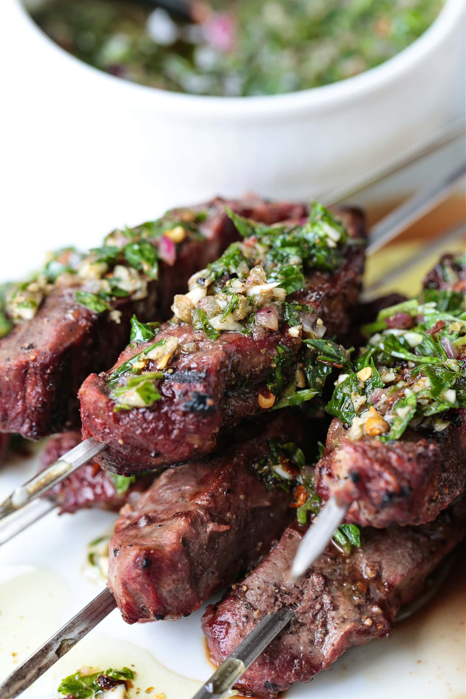 chimichurri sauce spooned over beef kabobs