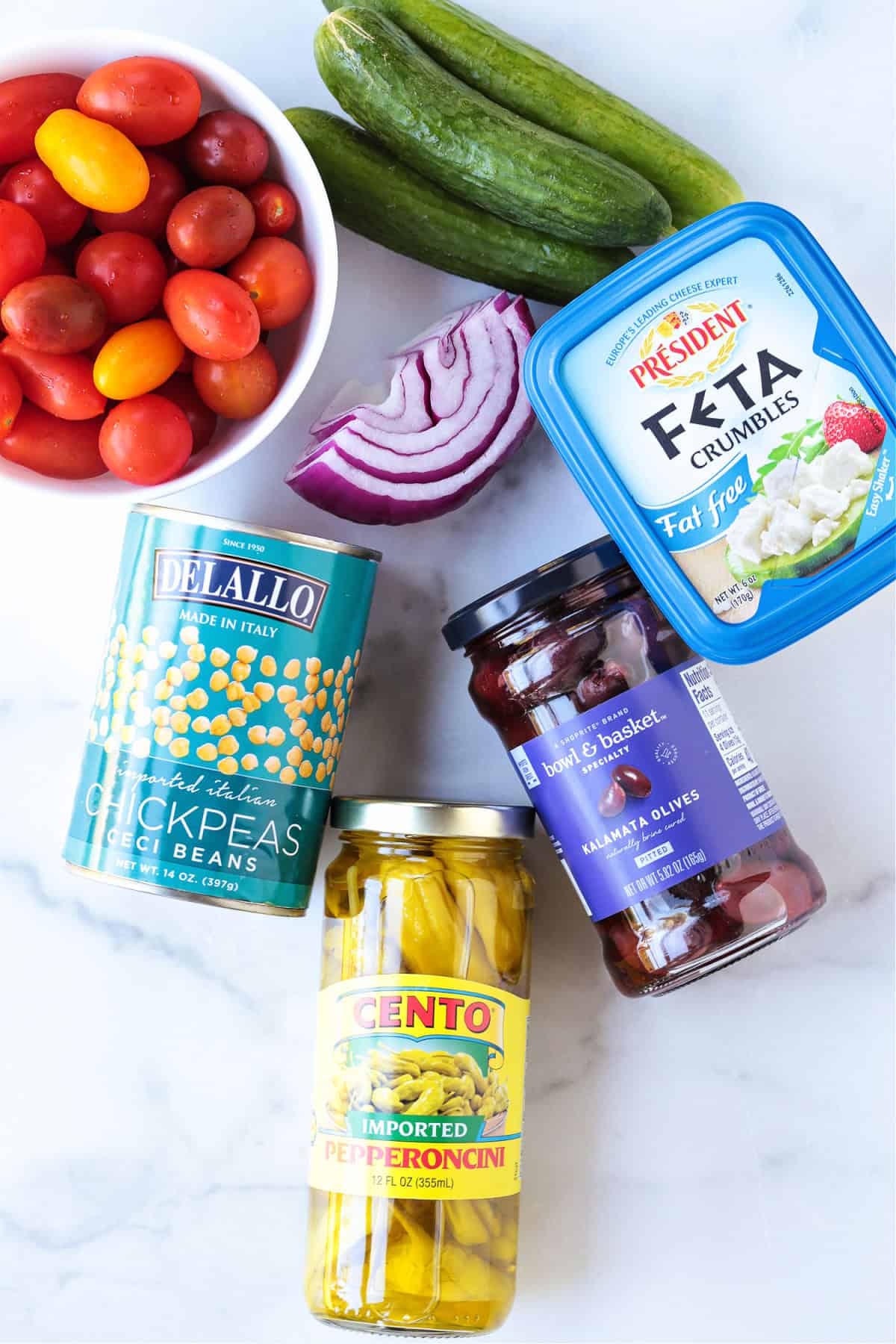 Greek Chickpea Salad is a taste-bud sensation! Loaded with crunchy vegetables, chickpeas and feta cheese tossed in a red wine vinaigrette.