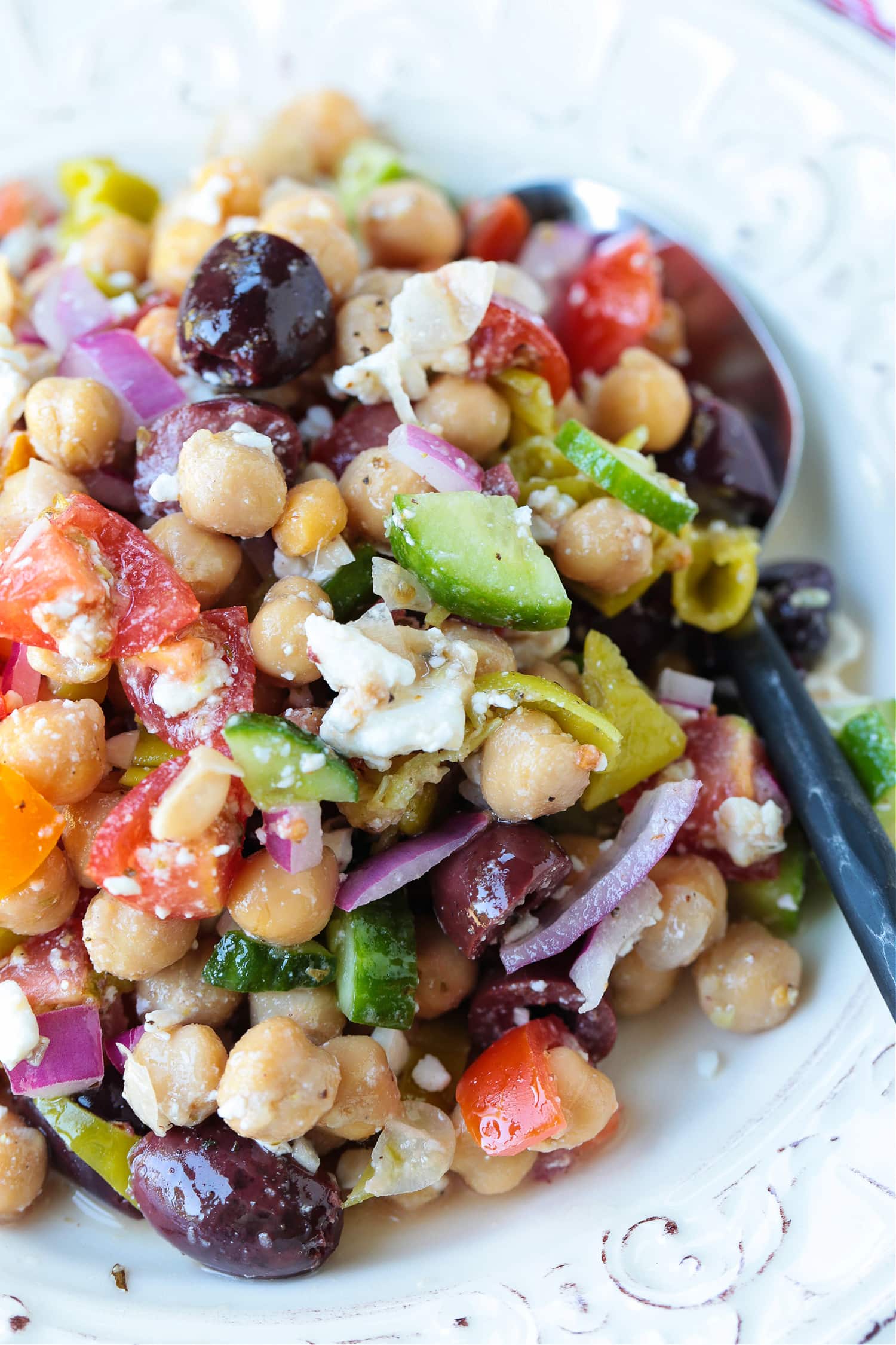 greek chickpea salad on plate with spoon