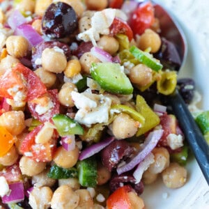 chickpea salad with vegetables and spoon on side