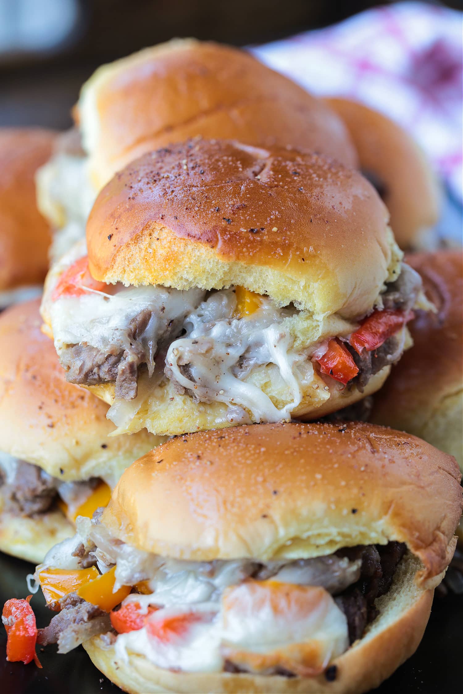 beef sliders with peppers, onions and cheese