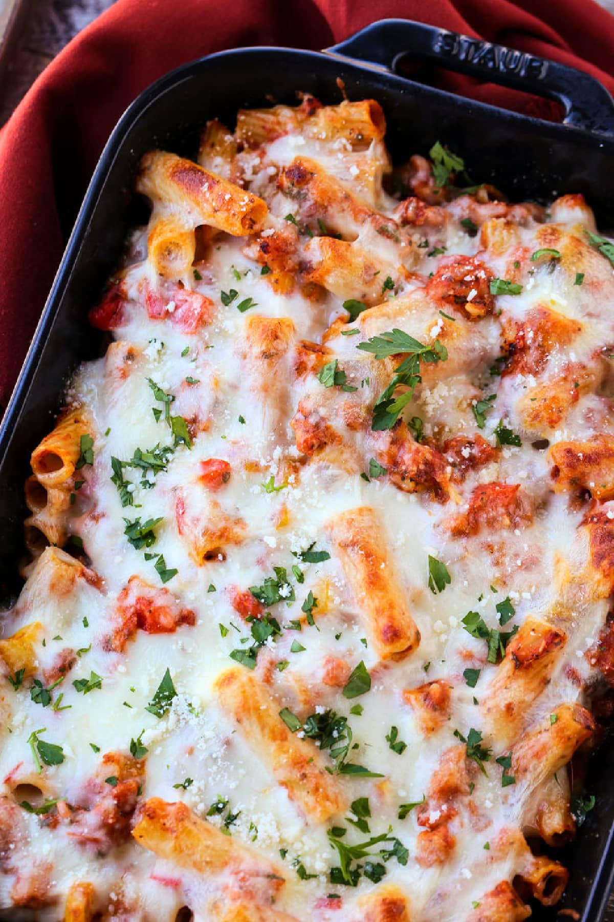 baked ziti with sausage and peppers in casserole dish