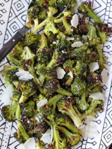 air fryer broccoli on platter with parmesan cheese