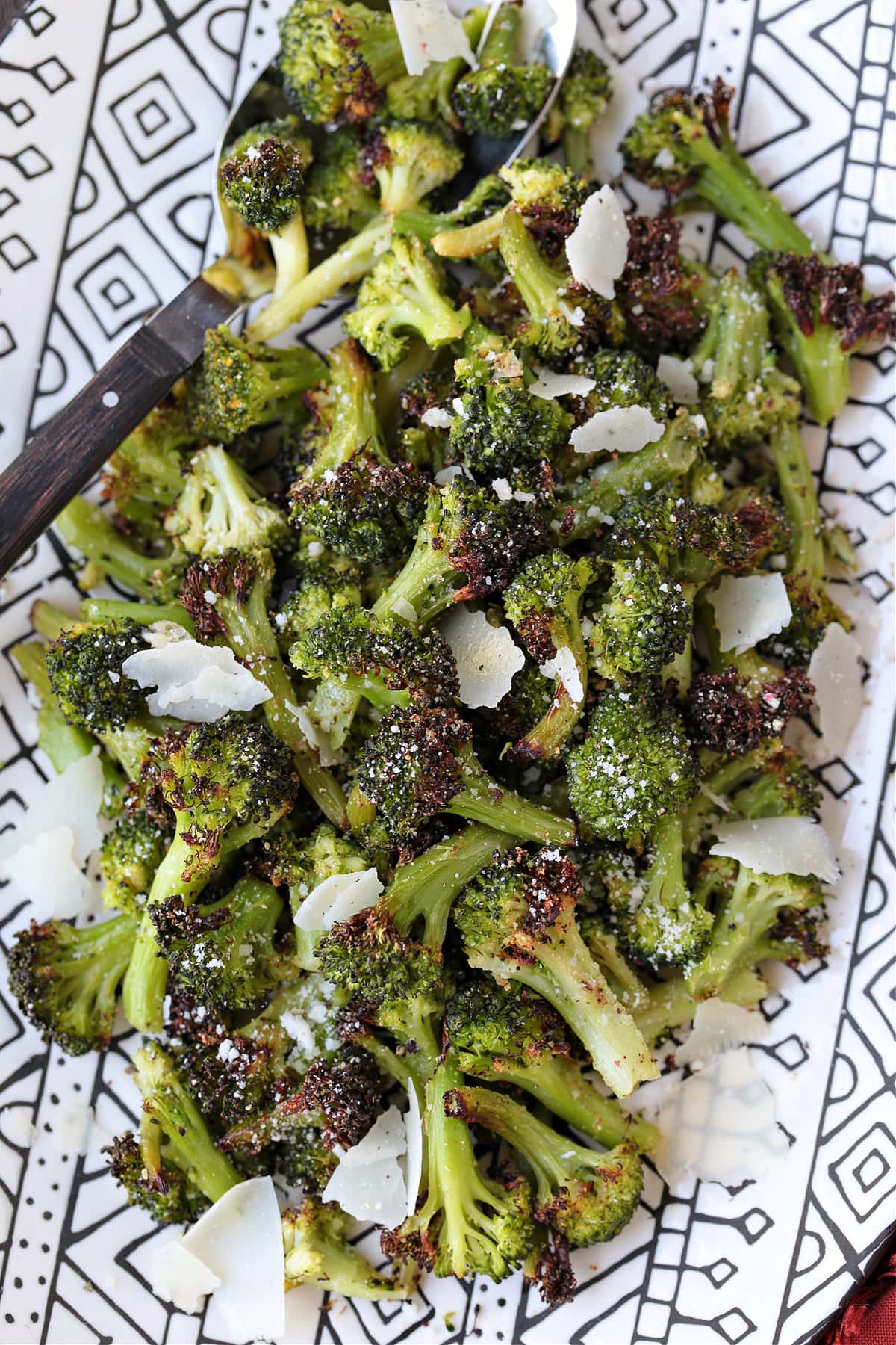 air fryer broccoli on platter with parmesan cheese