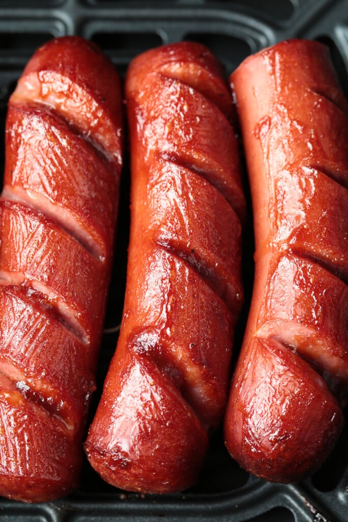 Air Fryer Kielbasa turns out crispy on the outside and super juicy on the inside! Just two ingredients and less than 10 minutes to make! kielbasa with bbq sauce in air fryer