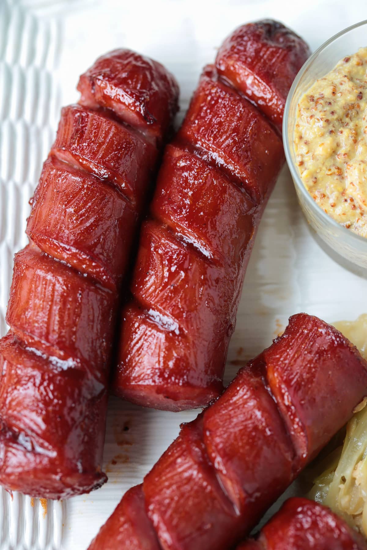 Air Fryer Kielbasa turns out crispy on the outside and super juicy on the inside! Just two ingredients and less than 10 minutes to make! kielbasa on a plate with cabbage