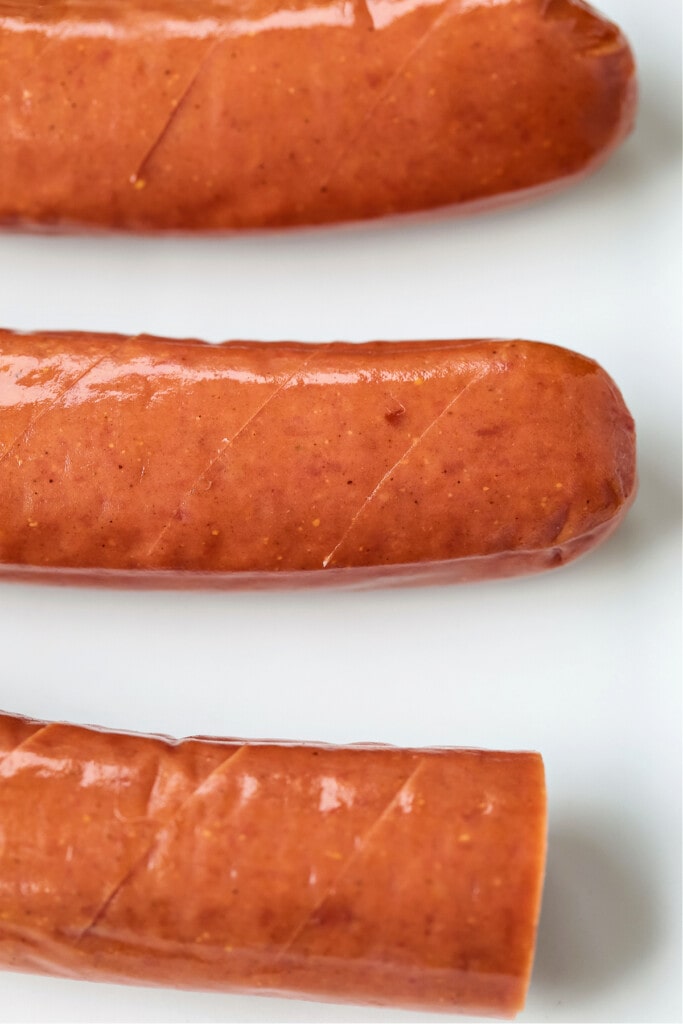 Air Fryer Kielbasa turns out crispy on the outside and super juicy on the inside! Just two ingredients and less than 10 minutes to make! kielbasa scored with a knife
