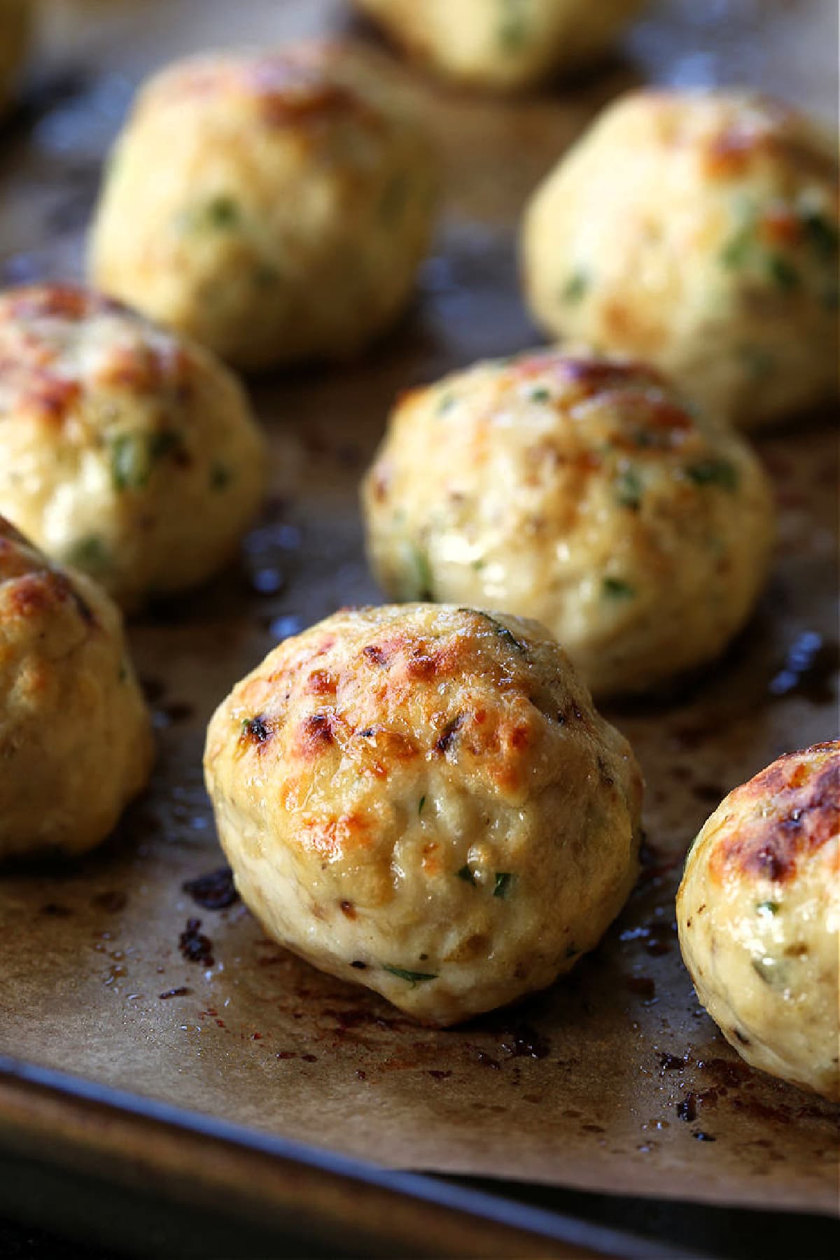 baked chicken meatballs on a sheet pan