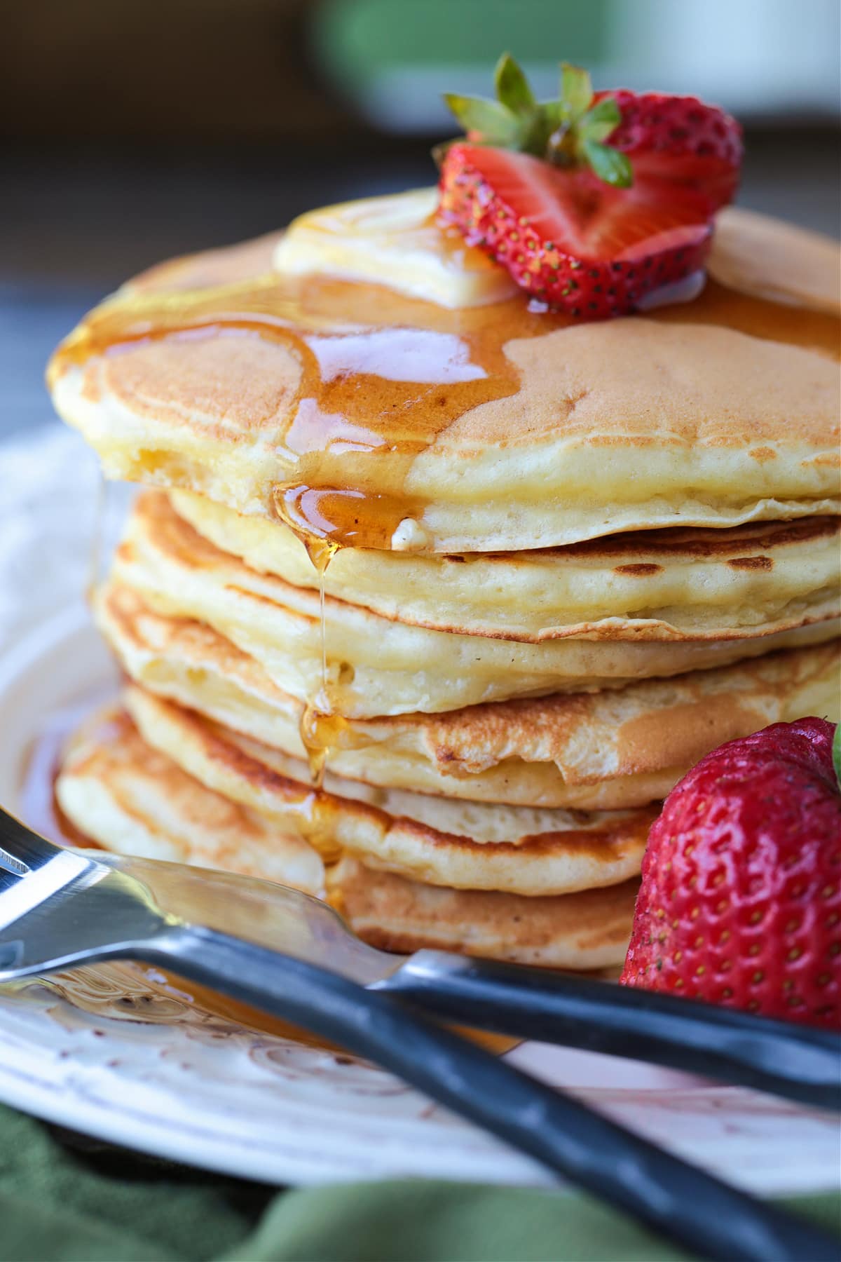 stack of pancakes with syrup dripping down
