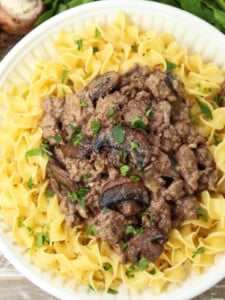 ground beef stroganoff over noodles on plate