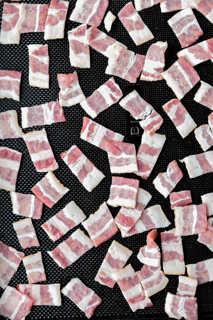raw diced bacon on a sheet pan