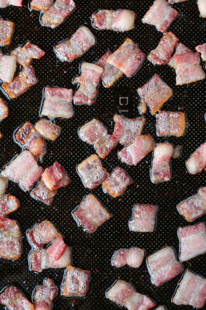 cooked diced bacon on a sheet pan
