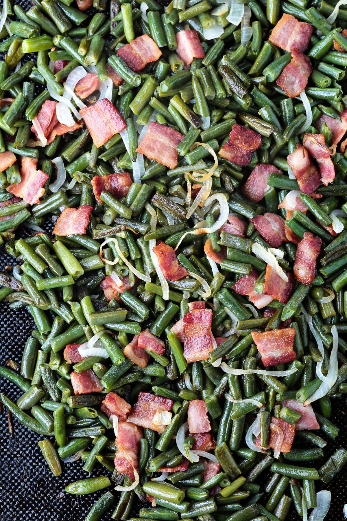green beans with bacon and onions on a sheet pan
